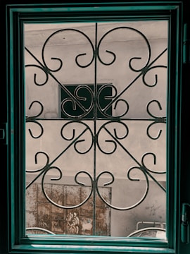A collection of decorative metal grills and gates displayed outdoors.