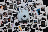 An assortment of colorful instant cameras arranged artfully on a bright surface.