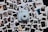 A collection of various instant photographs spread out on a surface with a light blue instant camera placed in the center. The photographs capture different scenes and people, featuring portraits, outdoor settings, and candid moments. The arrangement is casual and slightly overlapping.