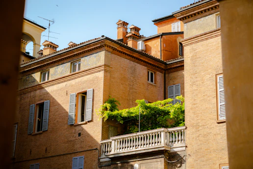 A cozy Italian rental home with a rustic balcony overlooking a charming street.