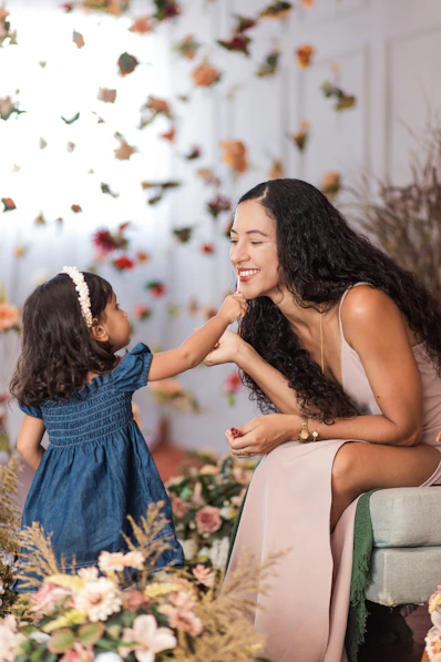 a woman and a little girl sitting next to each other