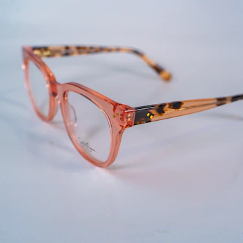 Close-up of pink and green kids' glasses with flexible frames.