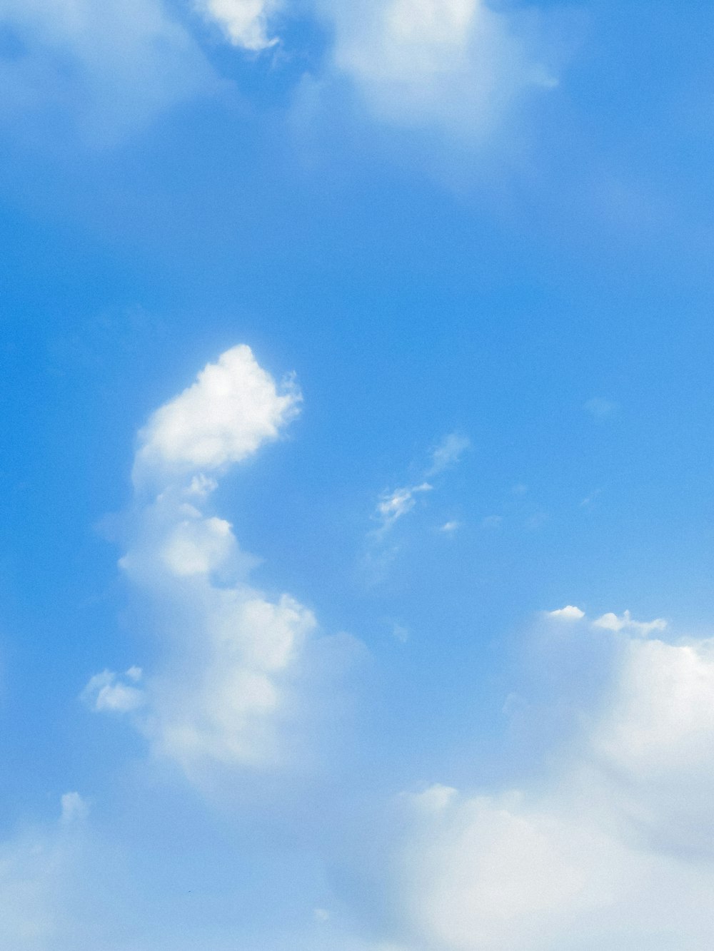 a plane flying in the sky with clouds