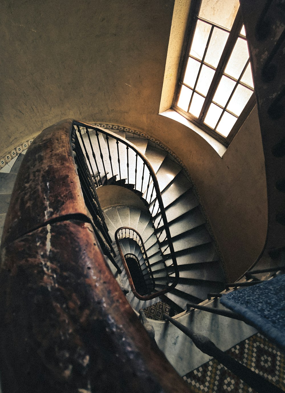 a spiral staircase in a building with a window