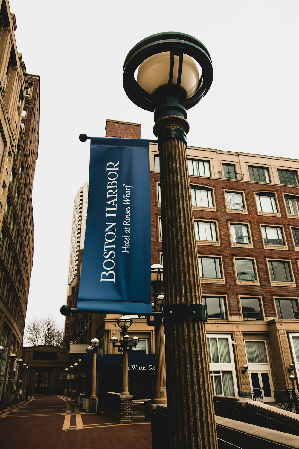 a street light with a blue banner hanging off of it's side