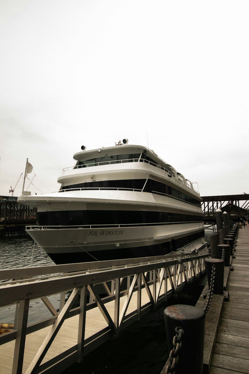 a large white boat docked at a pier