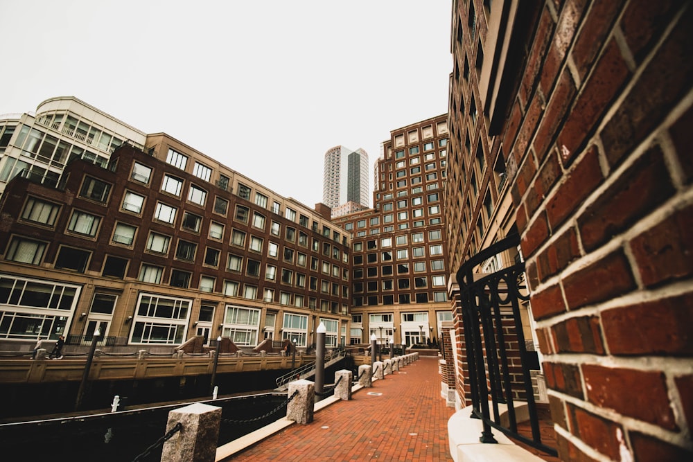 a brick walkway between two buildings in a city