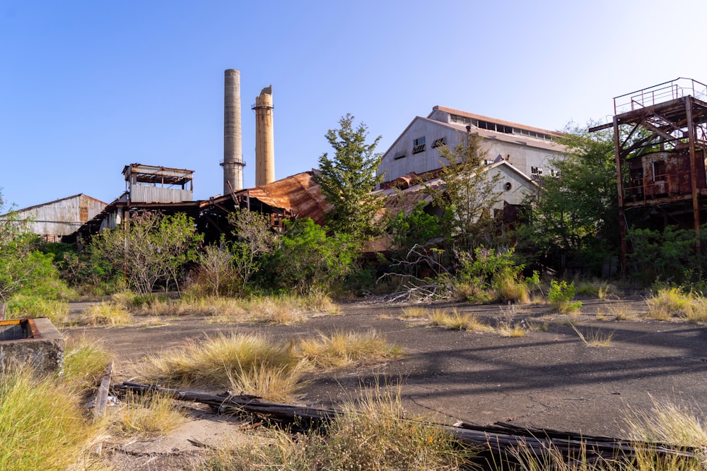 an abandoned factory building in the middle of a field