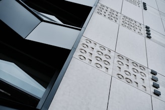 Close-up of a holographic network grid overlaying a government building, emphasizing secure, high-stakes environments.