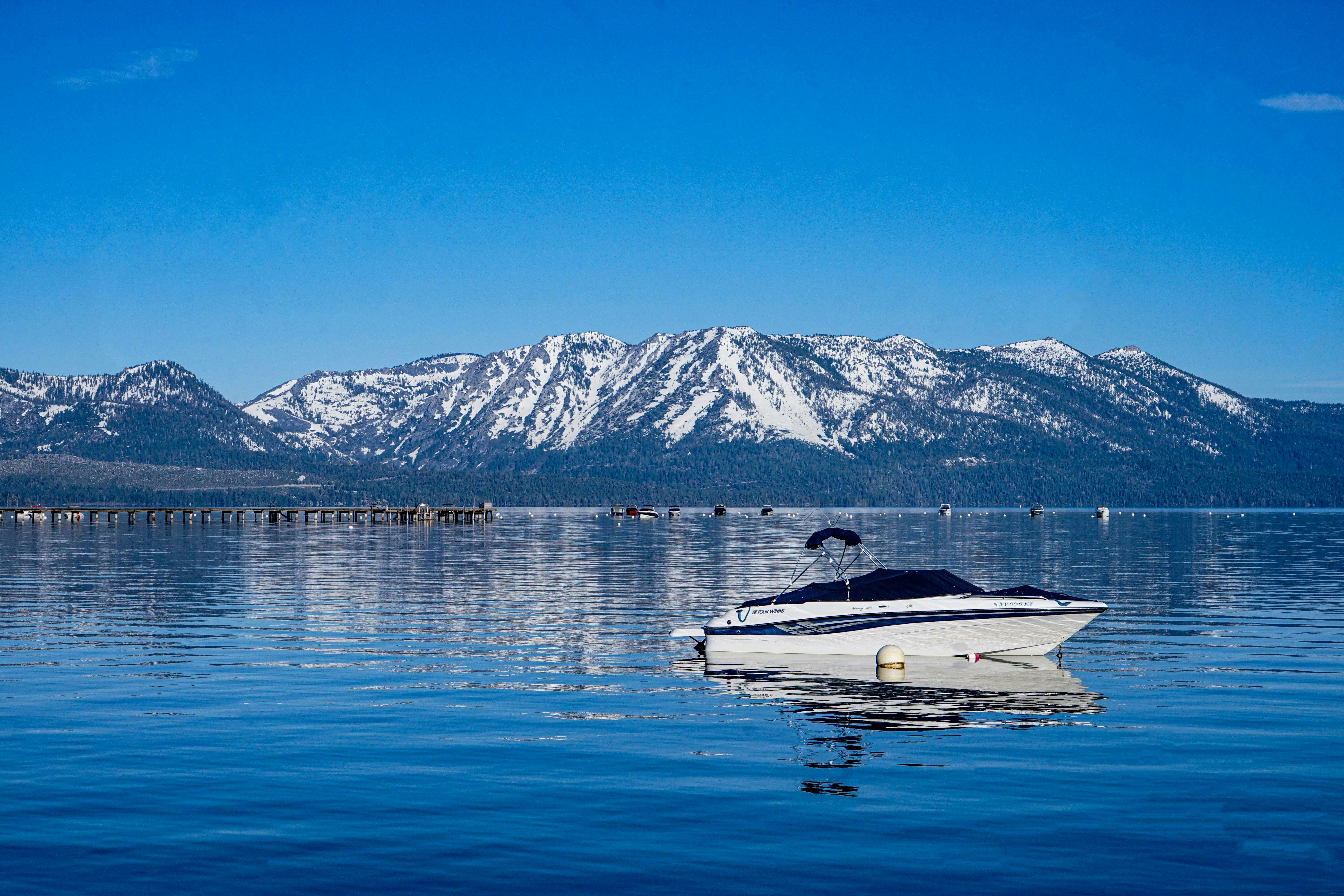 a white boat floating on top of a large body of water