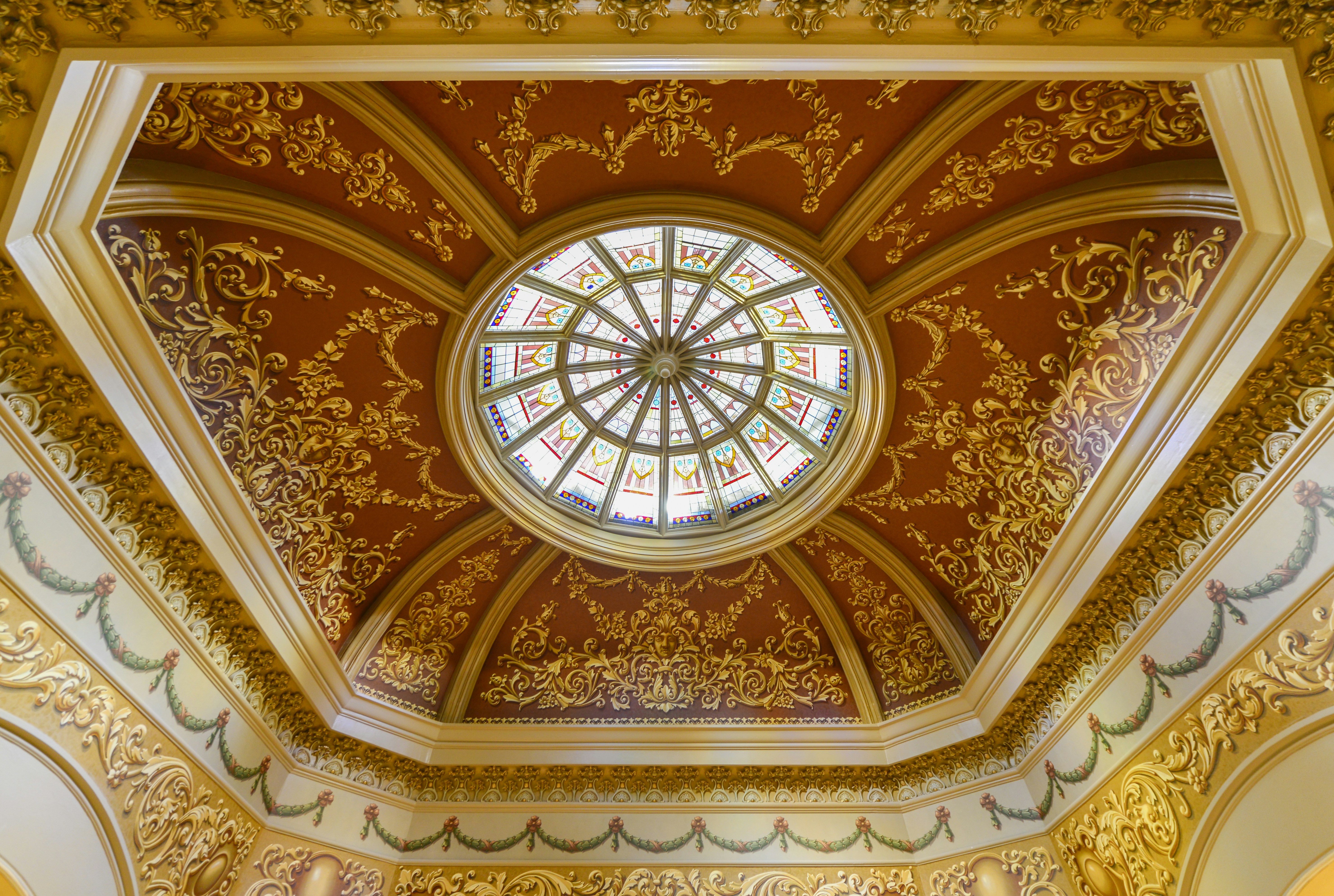 a ceiling with a circular glass window in it, Dome within the Wyoming State Capitol