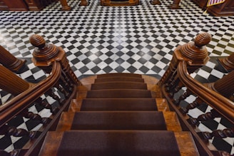 a set of stairs leading up to a checkered floor