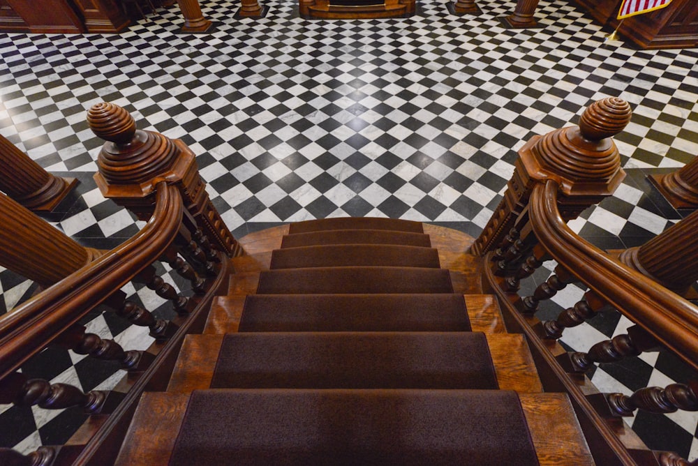 a set of stairs leading up to a checkered floor