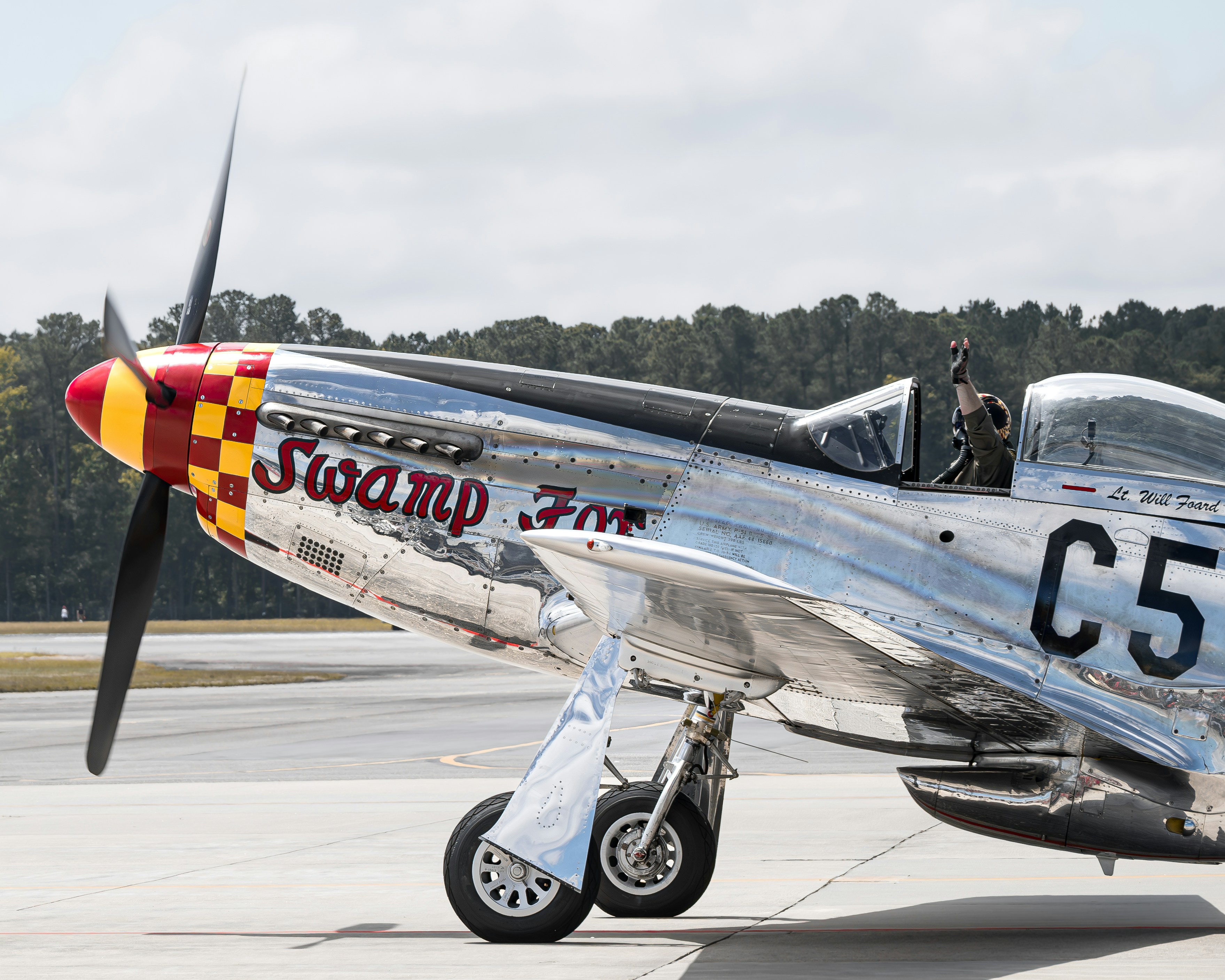 a silver and red airplane sitting on top of an airport tarmac, P51 Mustang "Swamp Fox" at Wings Over Wayne 2023