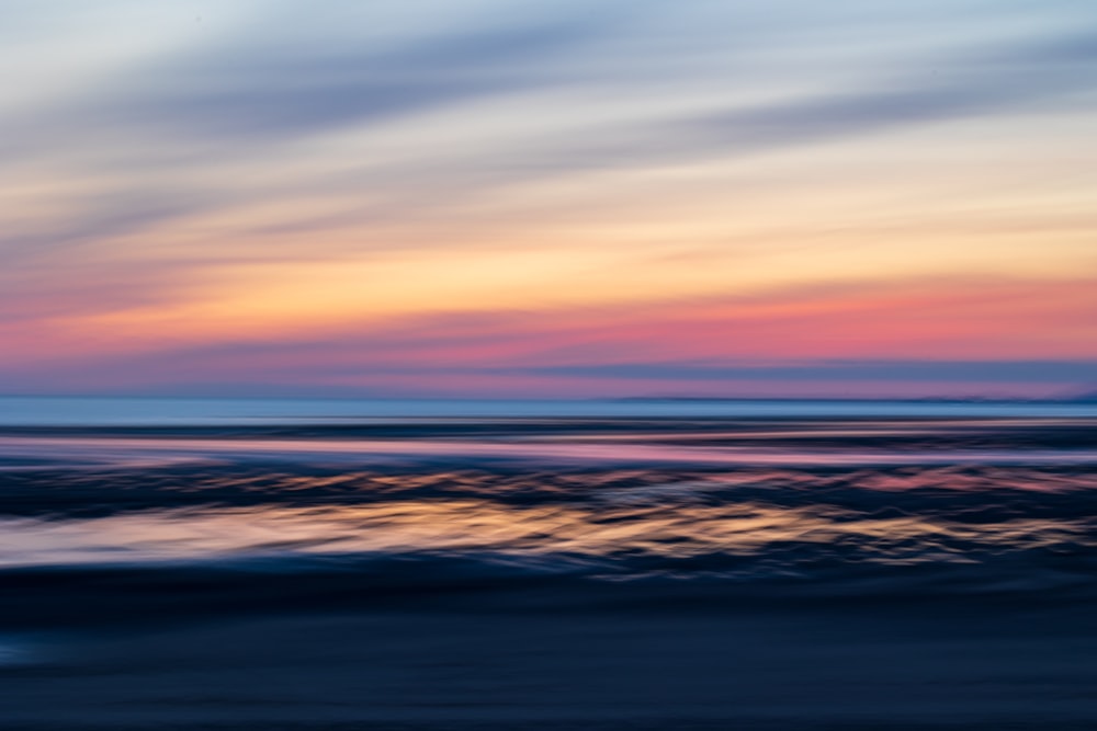 a blurry photo of a sunset over the ocean