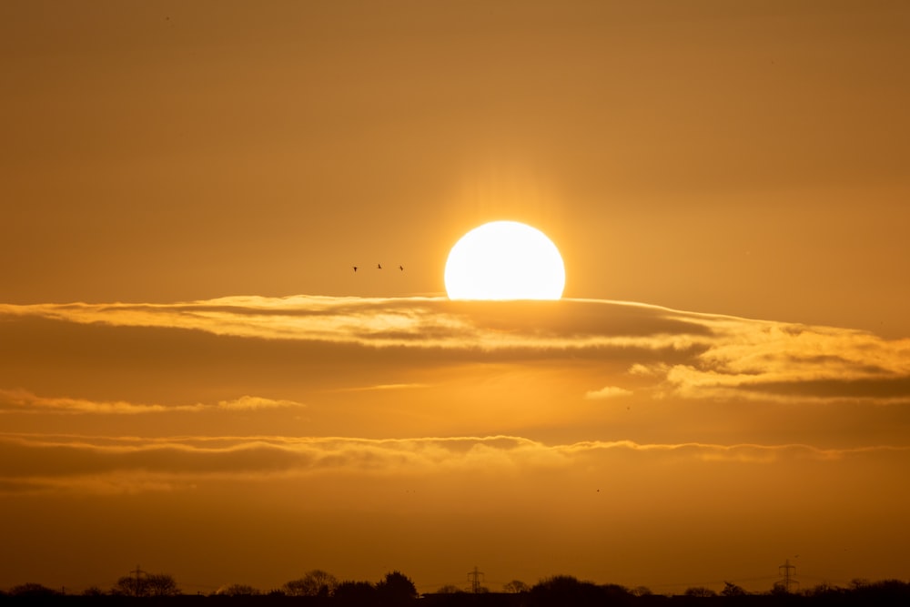 the sun is setting over the horizon of the sky