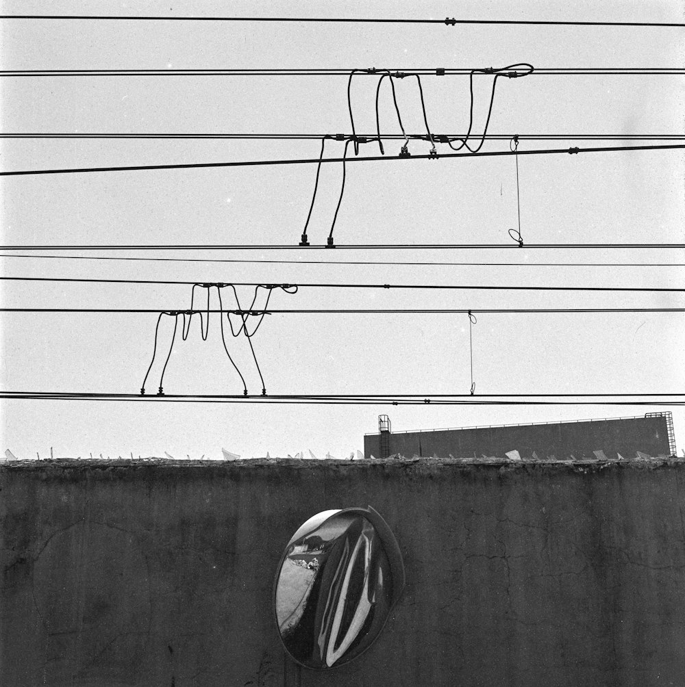 a black and white photo of a street sign and power lines