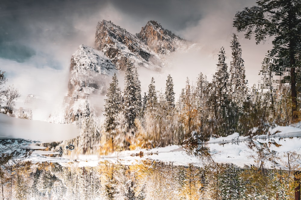 a mountain covered in snow next to a lake