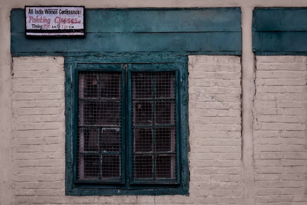 a brick building with a window and a sign on it