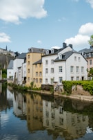 a body of water in front of a row of buildings