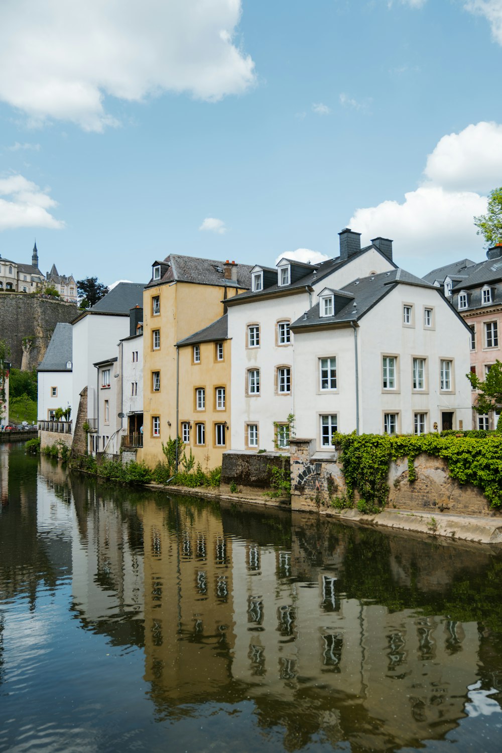 a body of water in front of a row of buildings