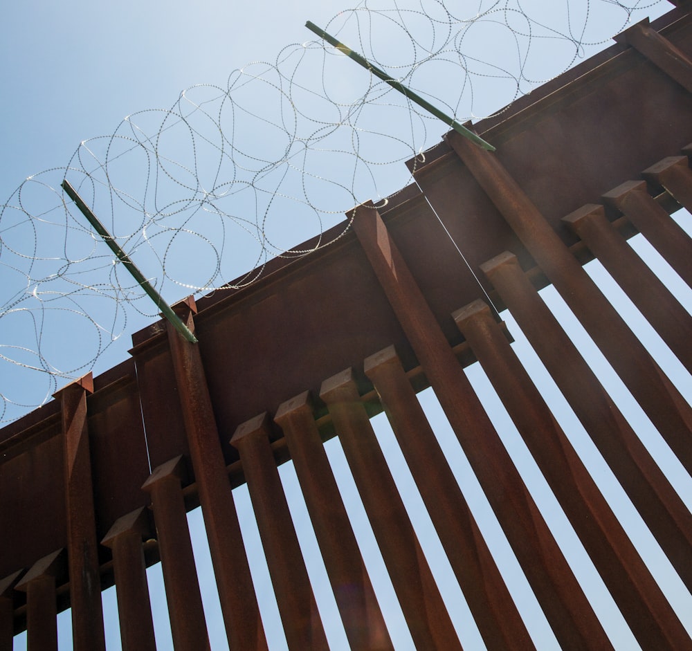 a close up of a fence with barbed wire