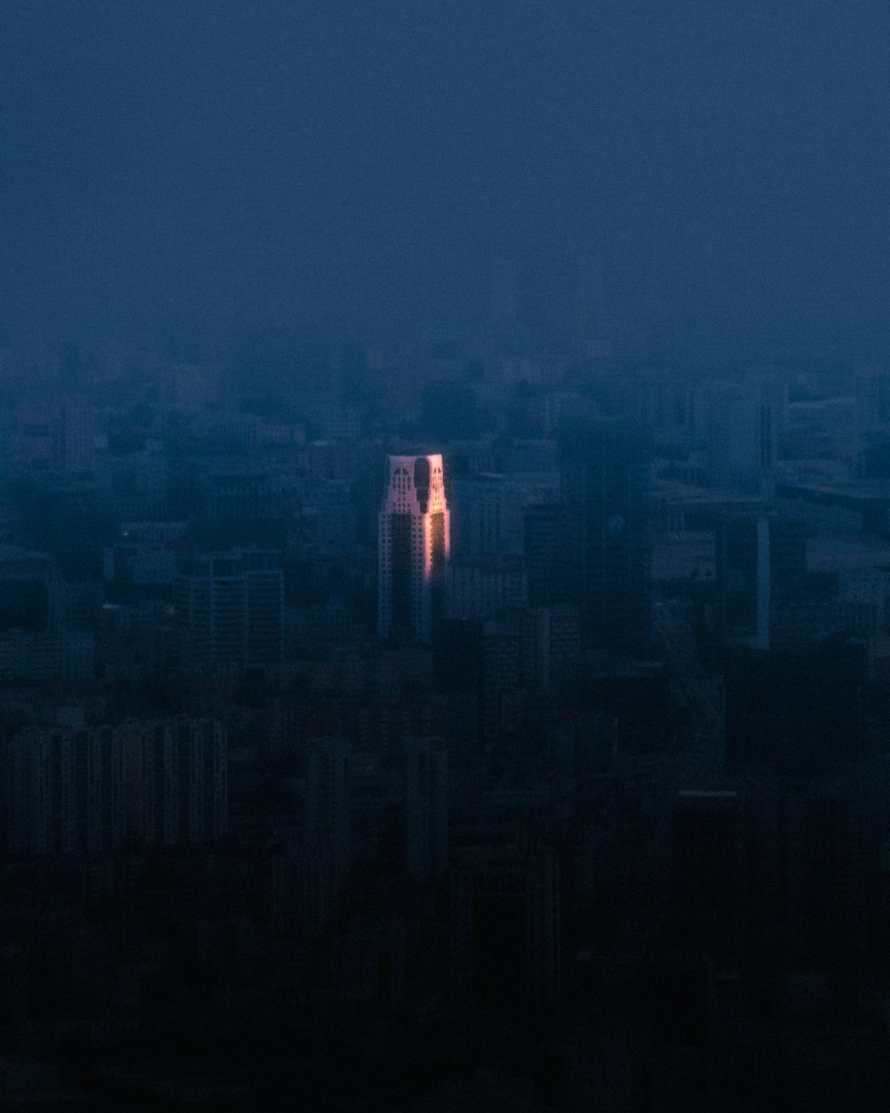 a view of a city at night from the top of a tall building