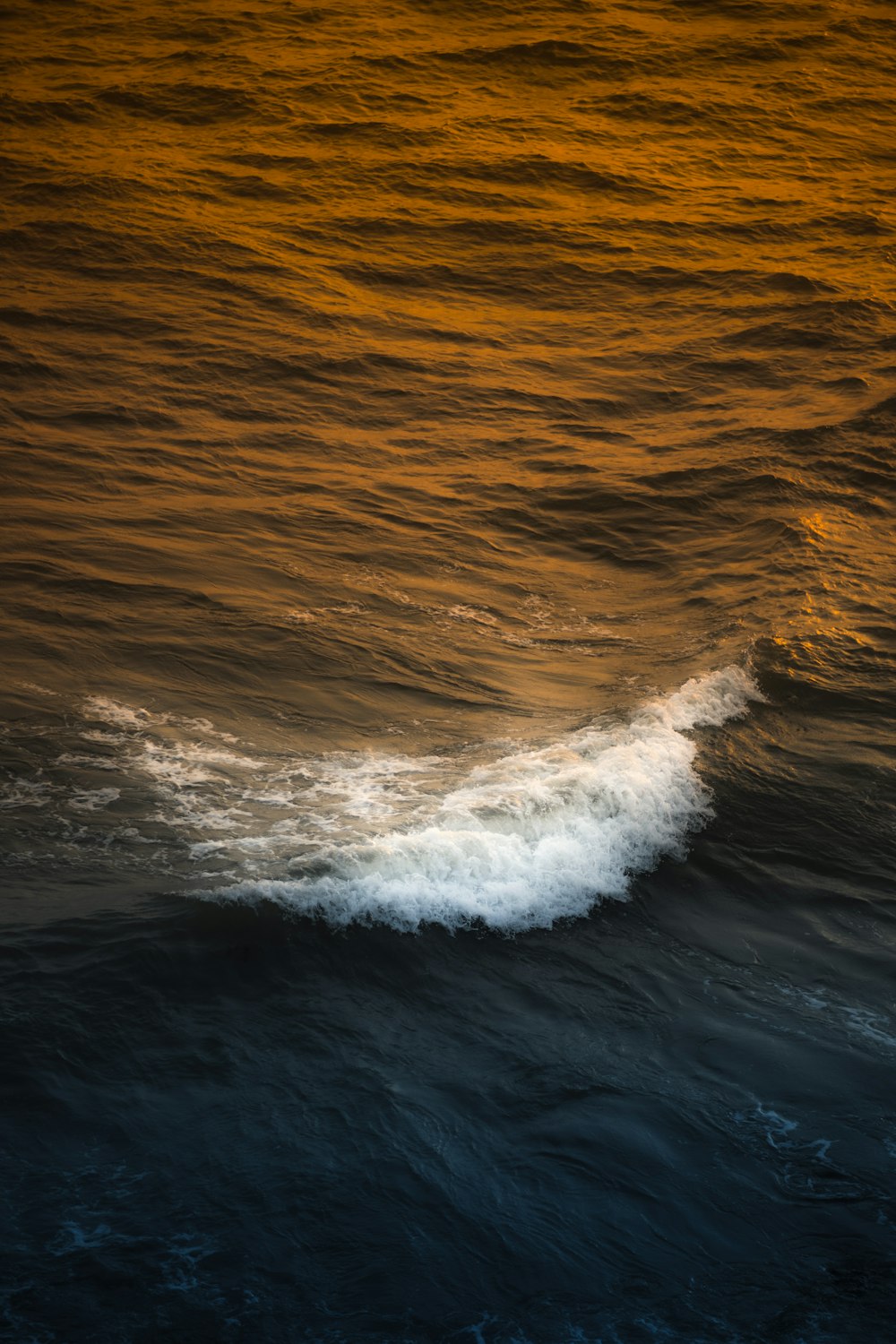 a large body of water with a wave coming in