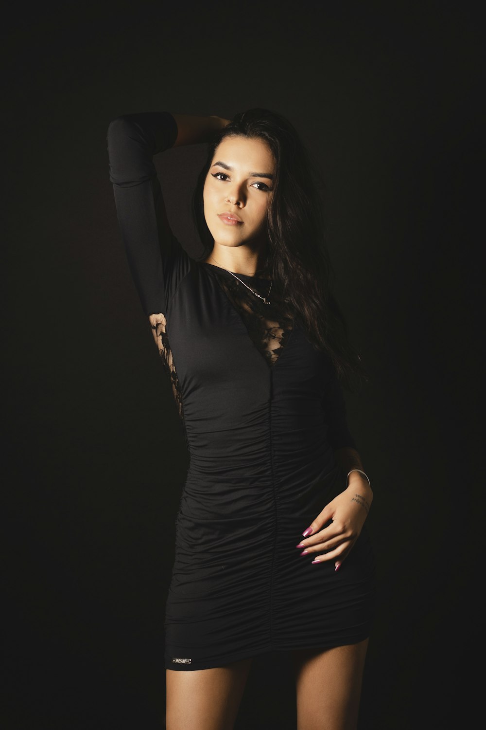 a woman in a black dress posing for a picture