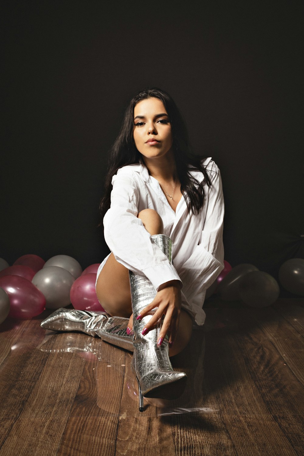 a woman sitting on the floor with her legs crossed