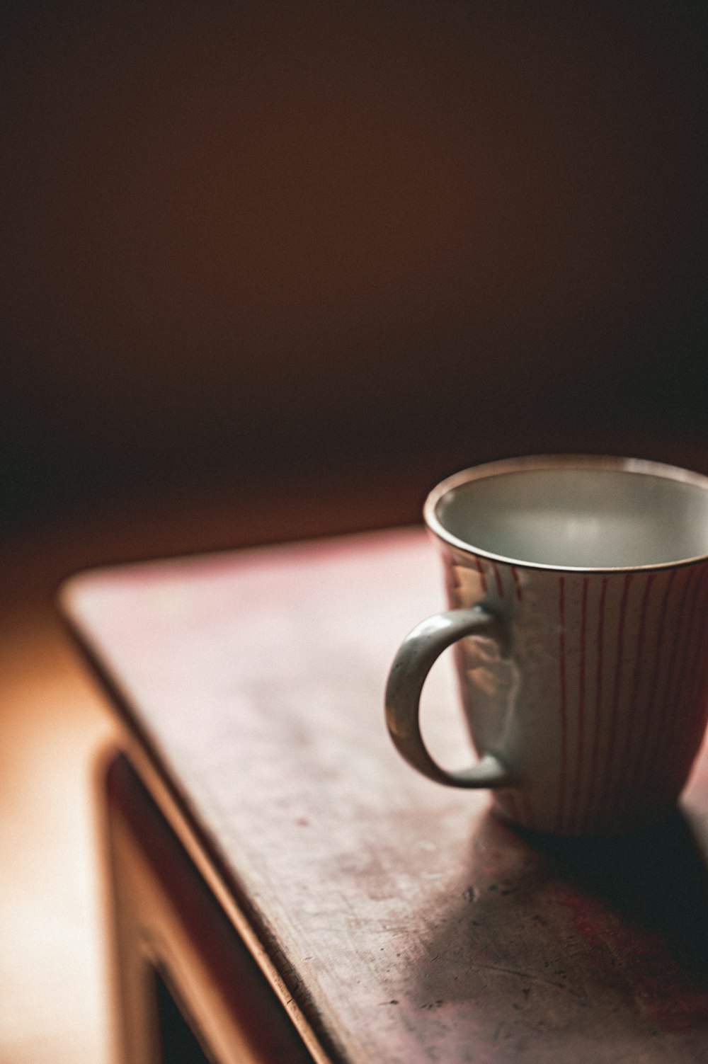 a coffee cup sitting on top of a wooden table