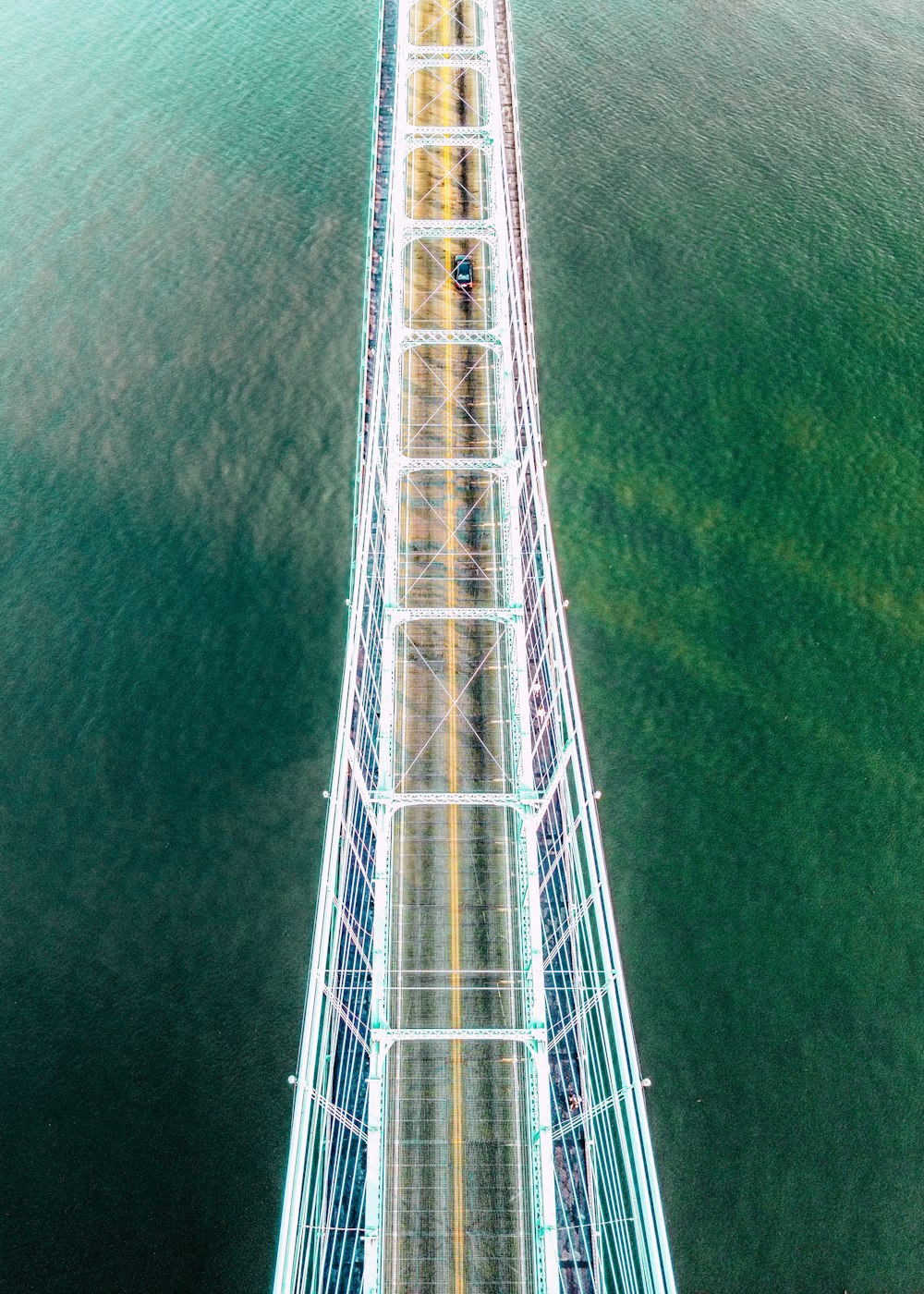 an aerial view of a bridge over a body of water