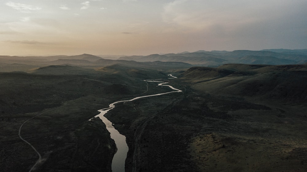 an aerial view of a river running through a valley