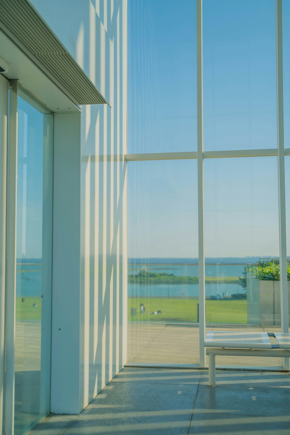 a bench sitting in front of a large window