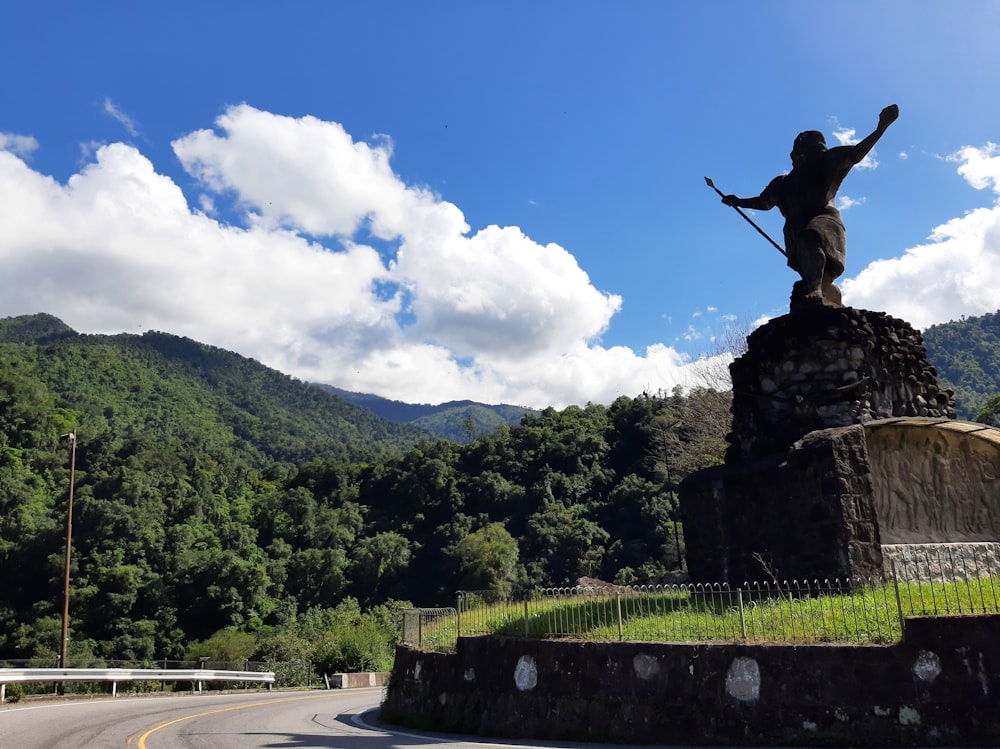 a statue of a man on top of a rock