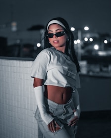 Model wearing Lumina Apparel outfit while sitting at a café table, capturing the blend of comfort and urban style.