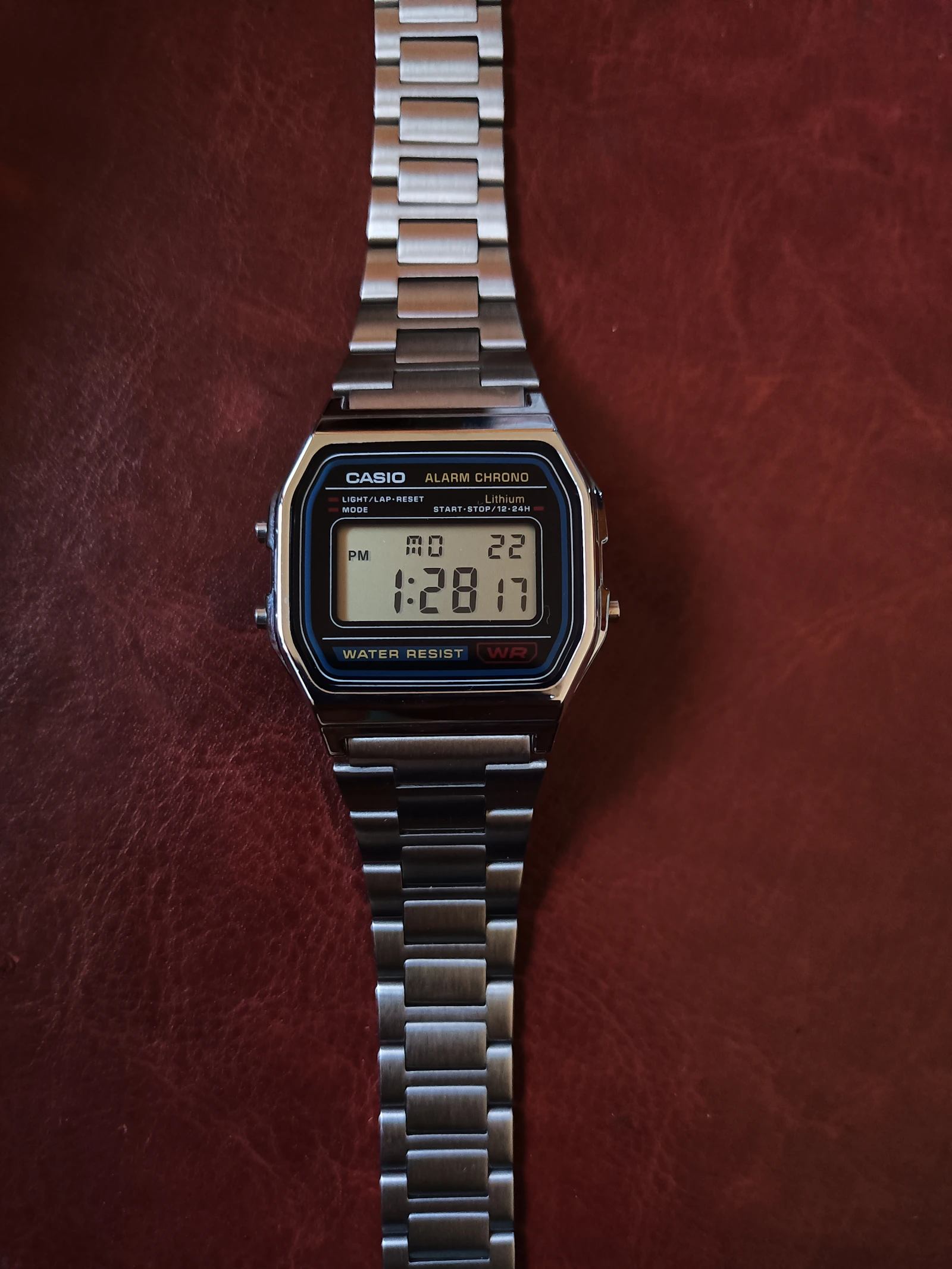 Casio vintage steel digital watch on red leather
