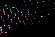 A sleek keyboard with colorful backlit keys glowing in a dim room.