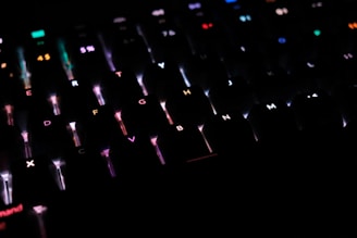 A close-up of a gaming keyboard with colorful backlighting.