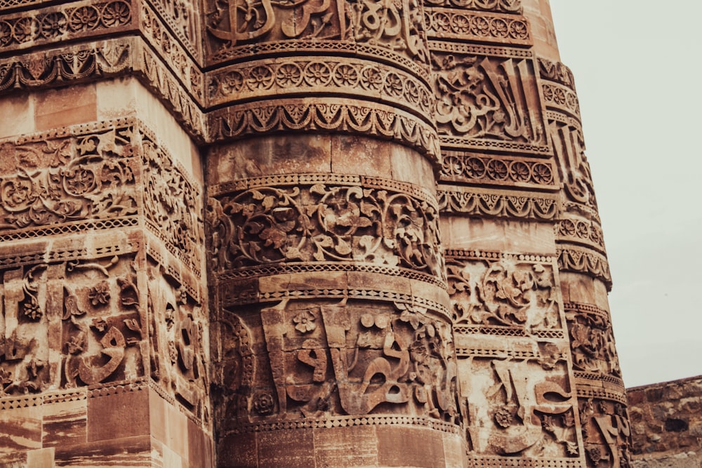 a tall tower with carvings on it's sides