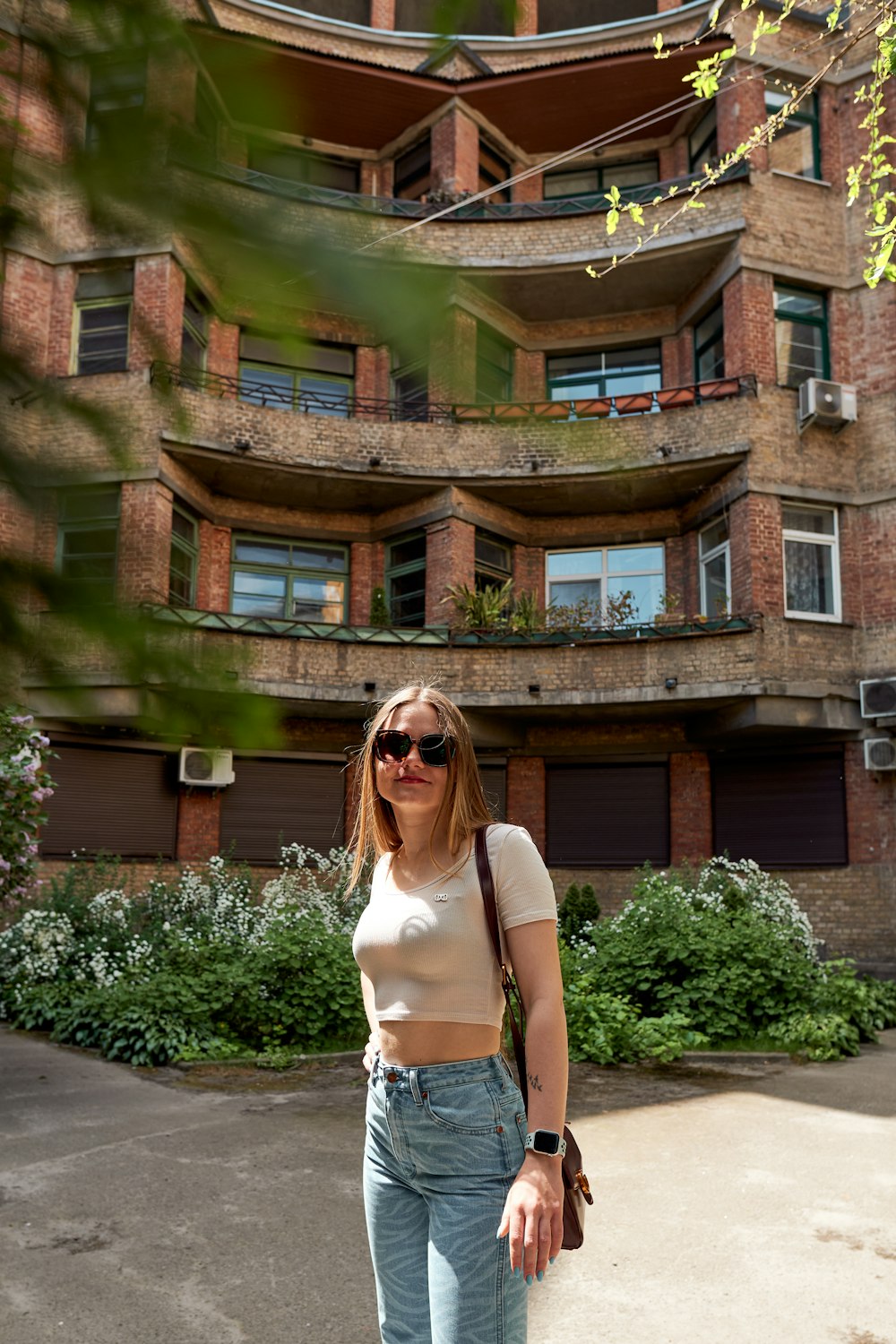 a woman standing on a skateboard in front of a building