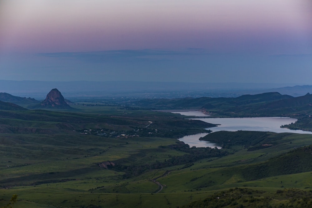 a view of a lake and mountains at dusk