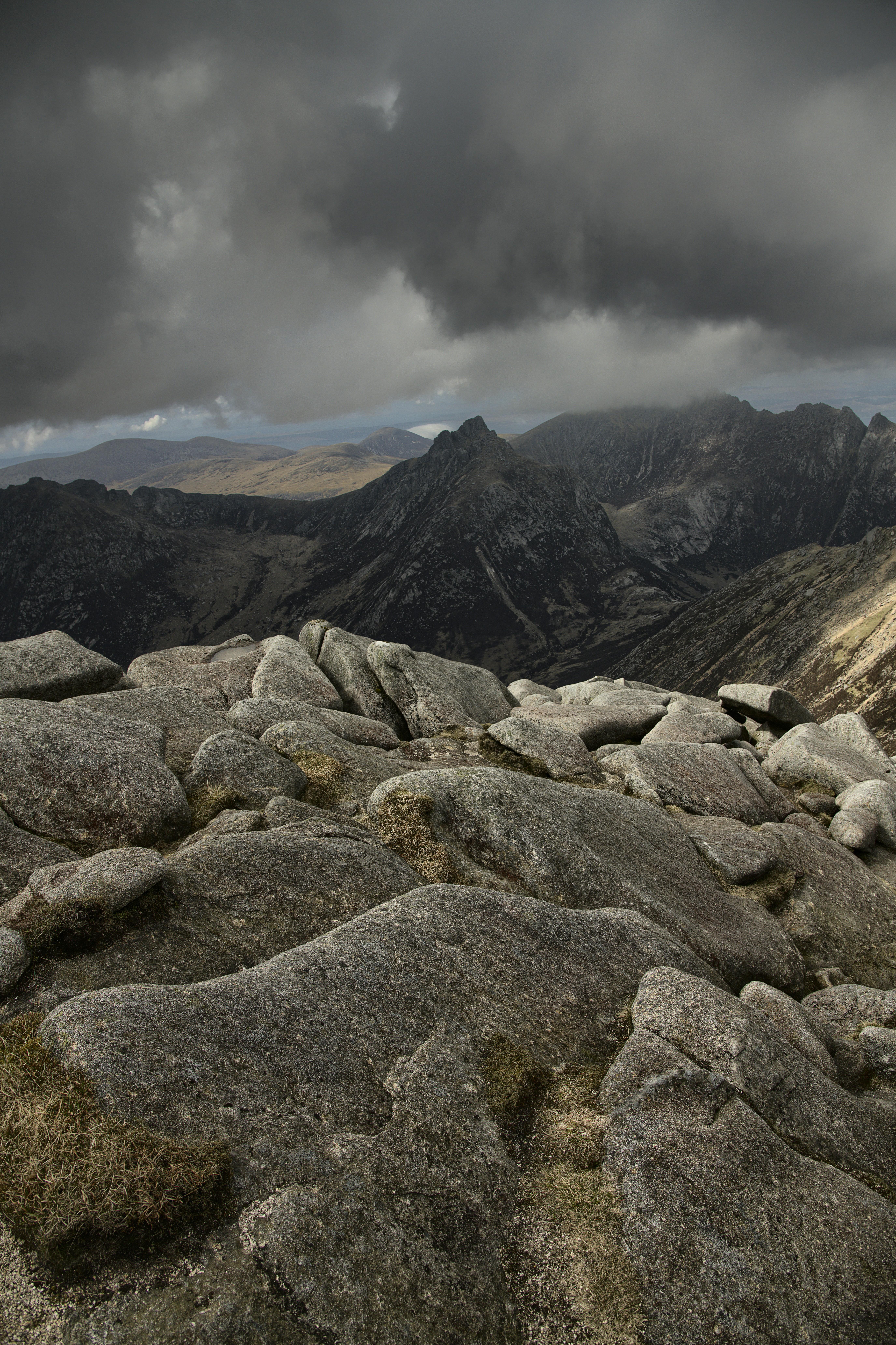 a view of the mountains from a rocky outcropping