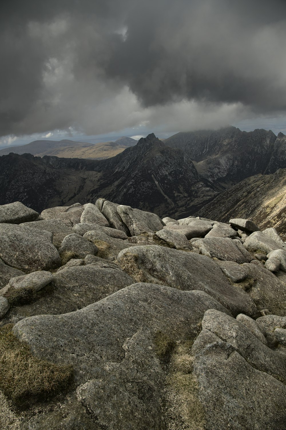 a view of the mountains from a rocky outcropping