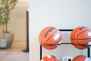 Basketballs stacked in a gym setting.