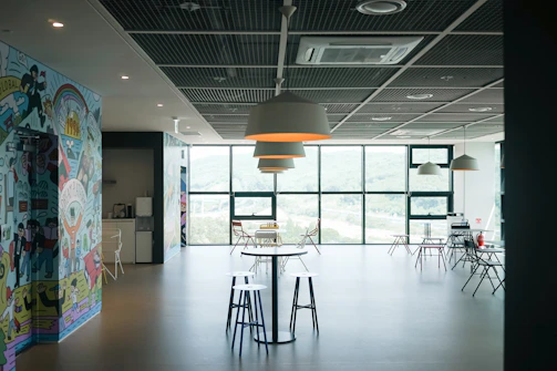 A quiet meeting room with minimalist design and a view of a calm garden outside.
