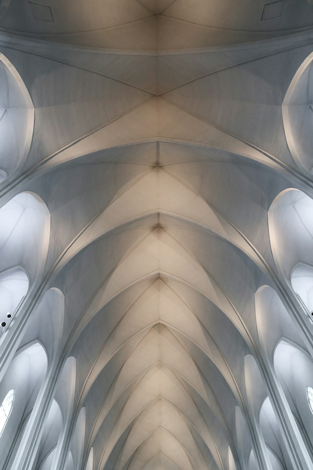 the ceiling of a large cathedral with many windows