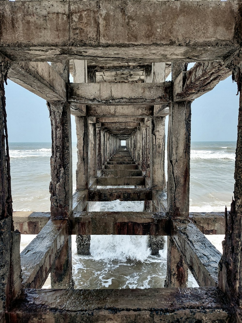 a long pier with water coming out of it