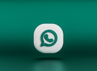 A clean website footer featuring a subtle floating chat icon.