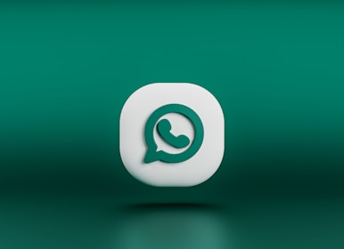 A three-dimensional icon resembling the logo of a chat application, featuring a white speech bubble with a green telephone handle inside. The icon is set against a gradient green background and appears to be floating.